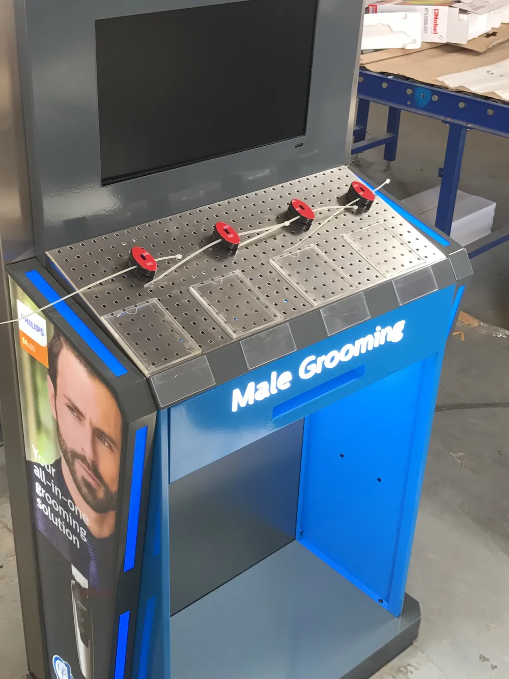 Male grooming floor display unit with screen and pegboard built by Ideal Design